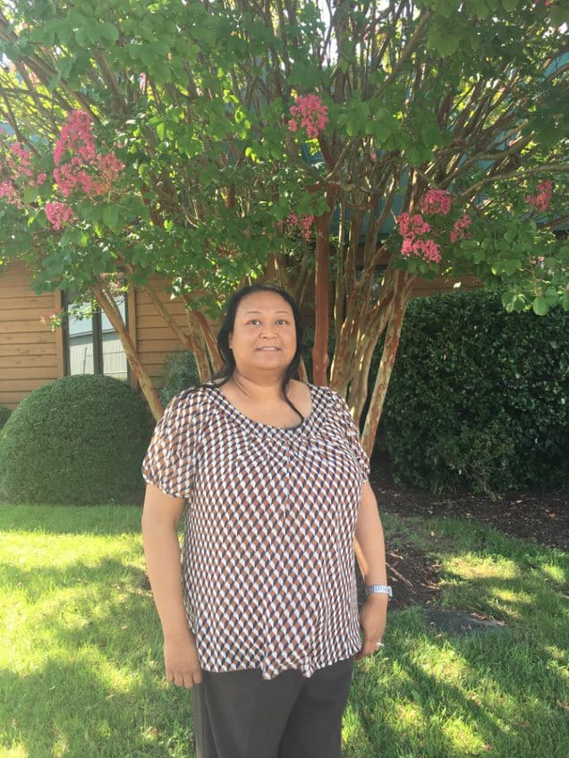 Sibil Holder, Project Engineer at Willow Construction, standing in front of a tree